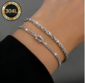 Tresse Argéntée Duo Bracelet Set – silver-tone rope and knot bracelets worn on wrist, grey background