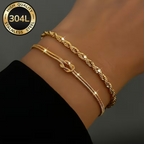 Tresse Dorée Duo Bracelet Set – 18K gold rope and knot bracelets worn on wrist, grey background